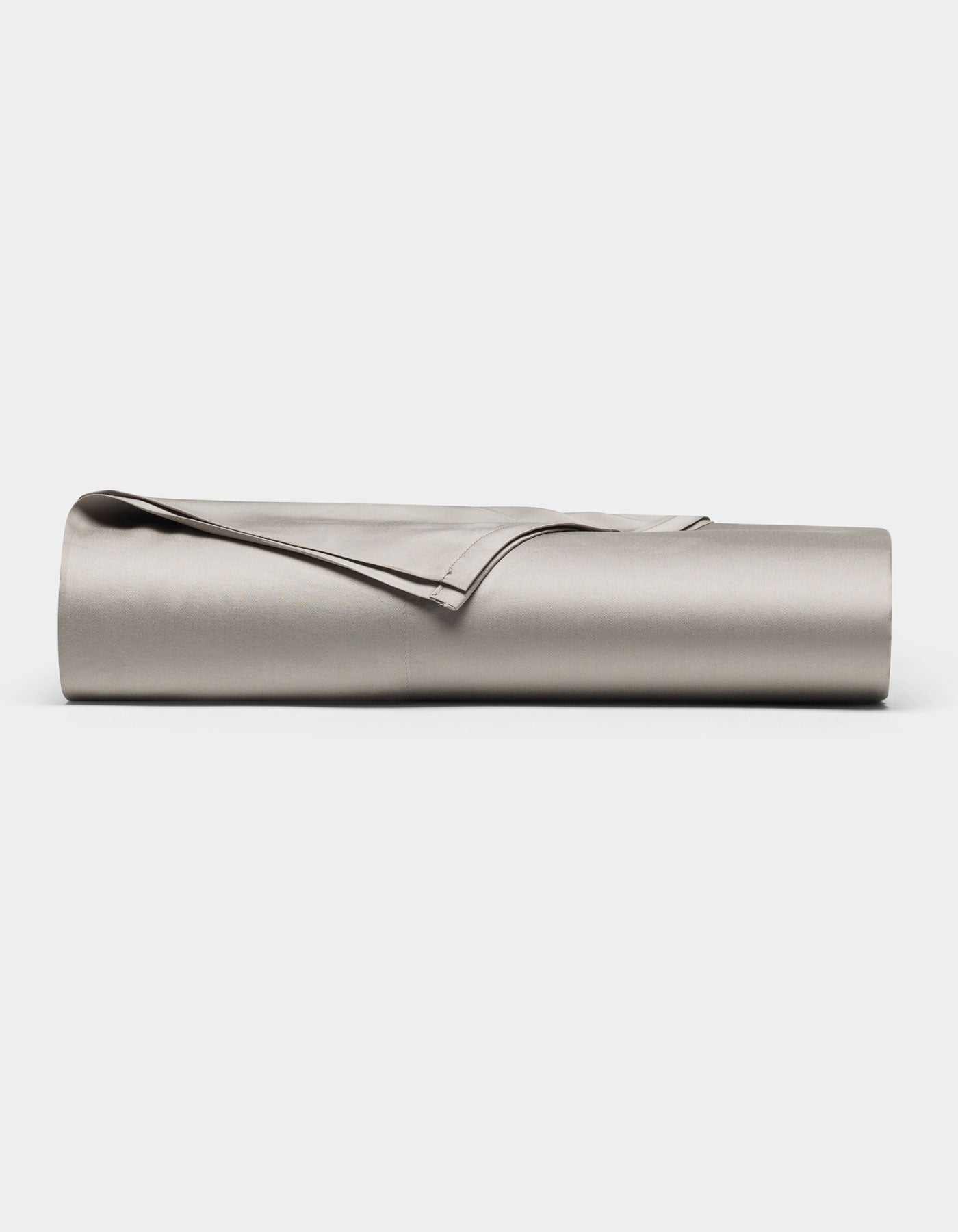 The Cozy Earth Bamboo Flat Sheet, in light gray, is neatly rolled and displayed on a plain white background.|Color:Dove Grey
