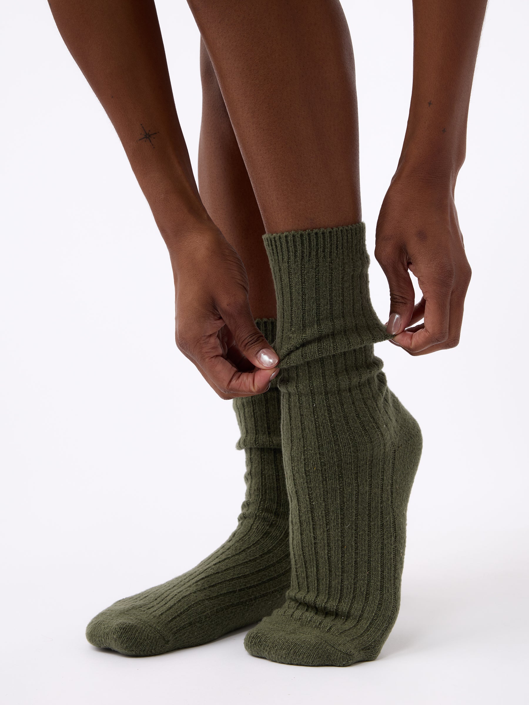 Person wearing Cozy Earth Plush Lounge Calf Sock 1-Pack in Olive |Color:Olive