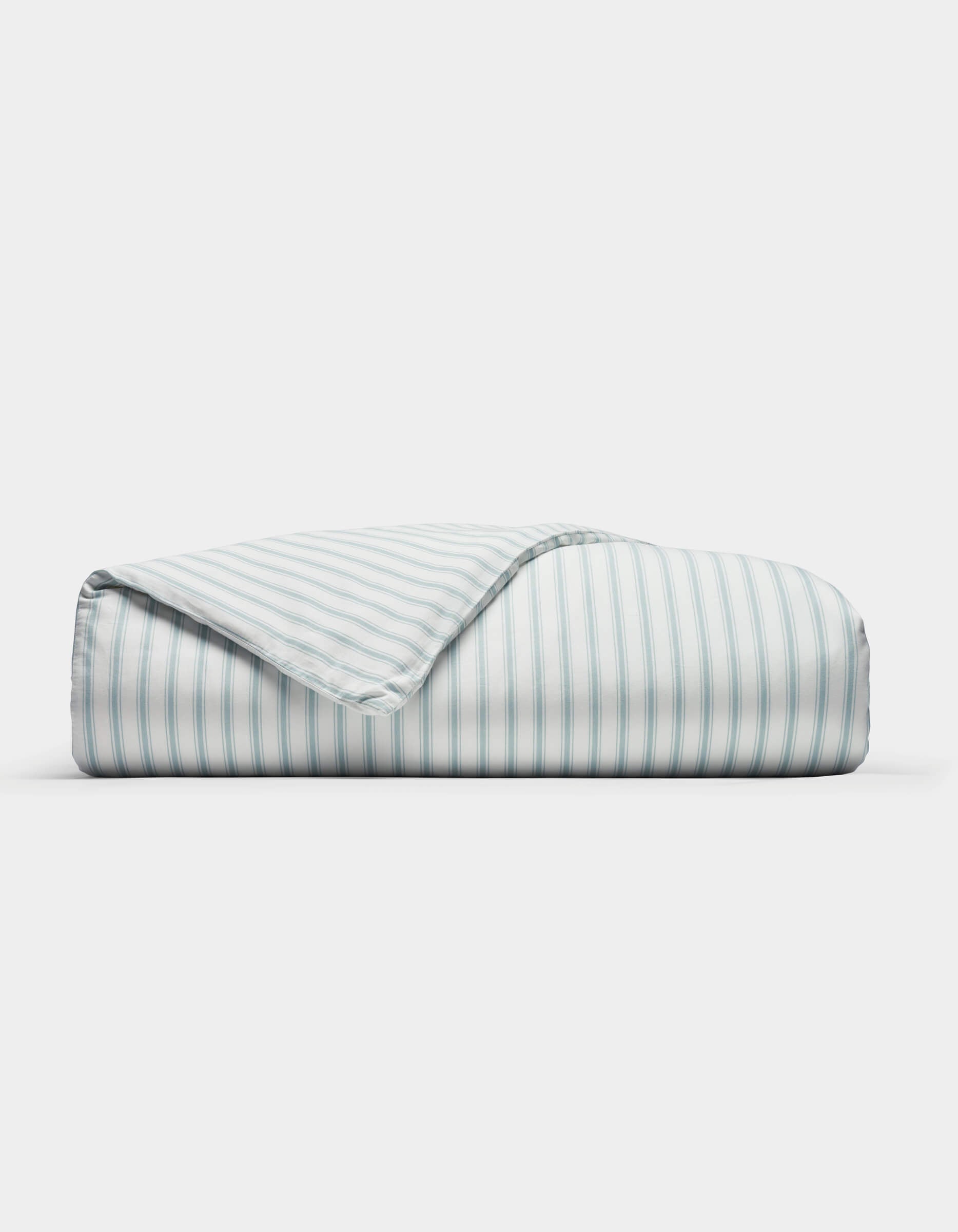 The Cozy Earth Soft-Wash Cotton Duvet Cover features neat light blue and white vertical stripes, displayed folded on a plain white background with one corner turned to show the underside pattern.|Color:River and Sea Salt Stripe