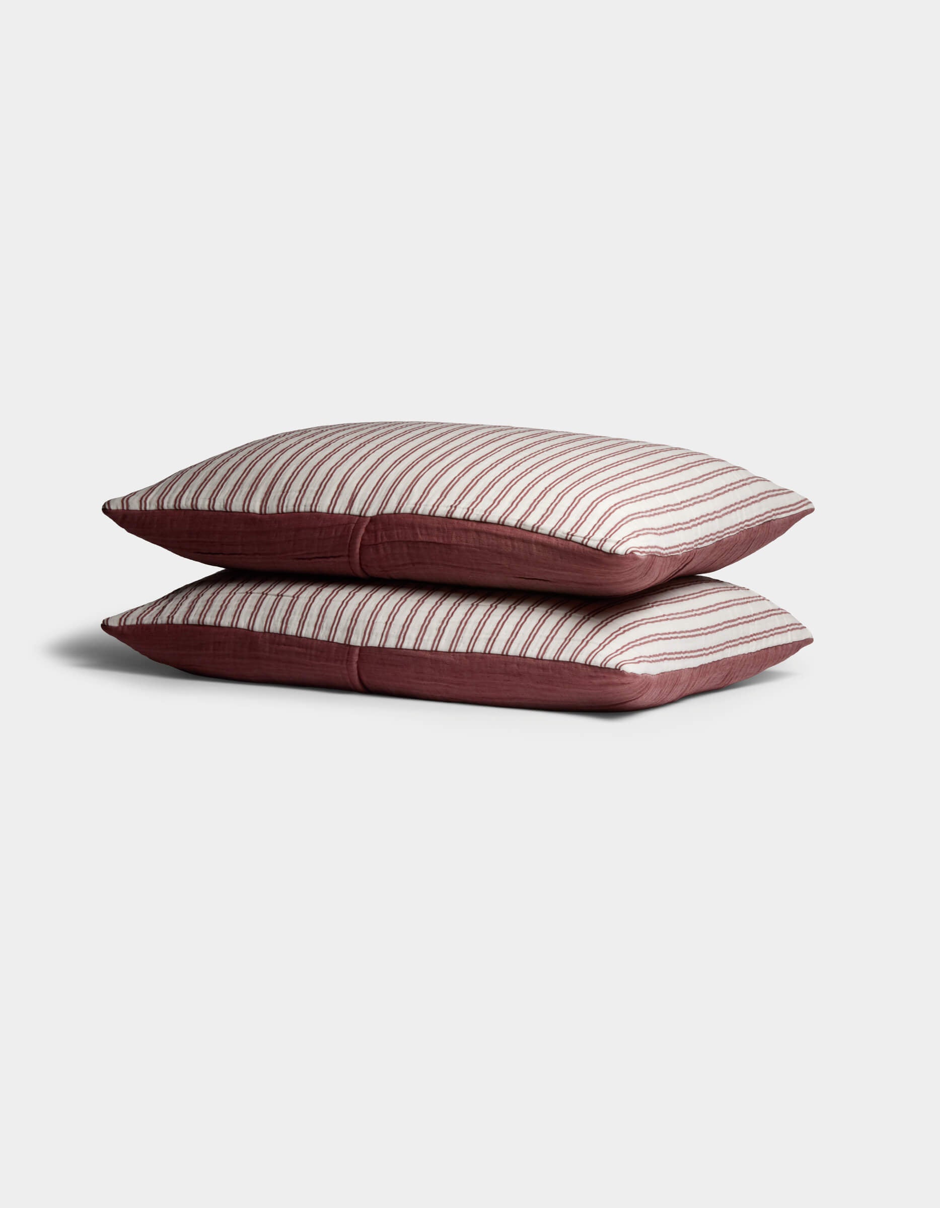 Two Waterfront Shams by Cozy Earth are stacked, showing a white top with thin horizontal red stripes and solid red sides, set against a plain light background.|Color:Currant Stripe