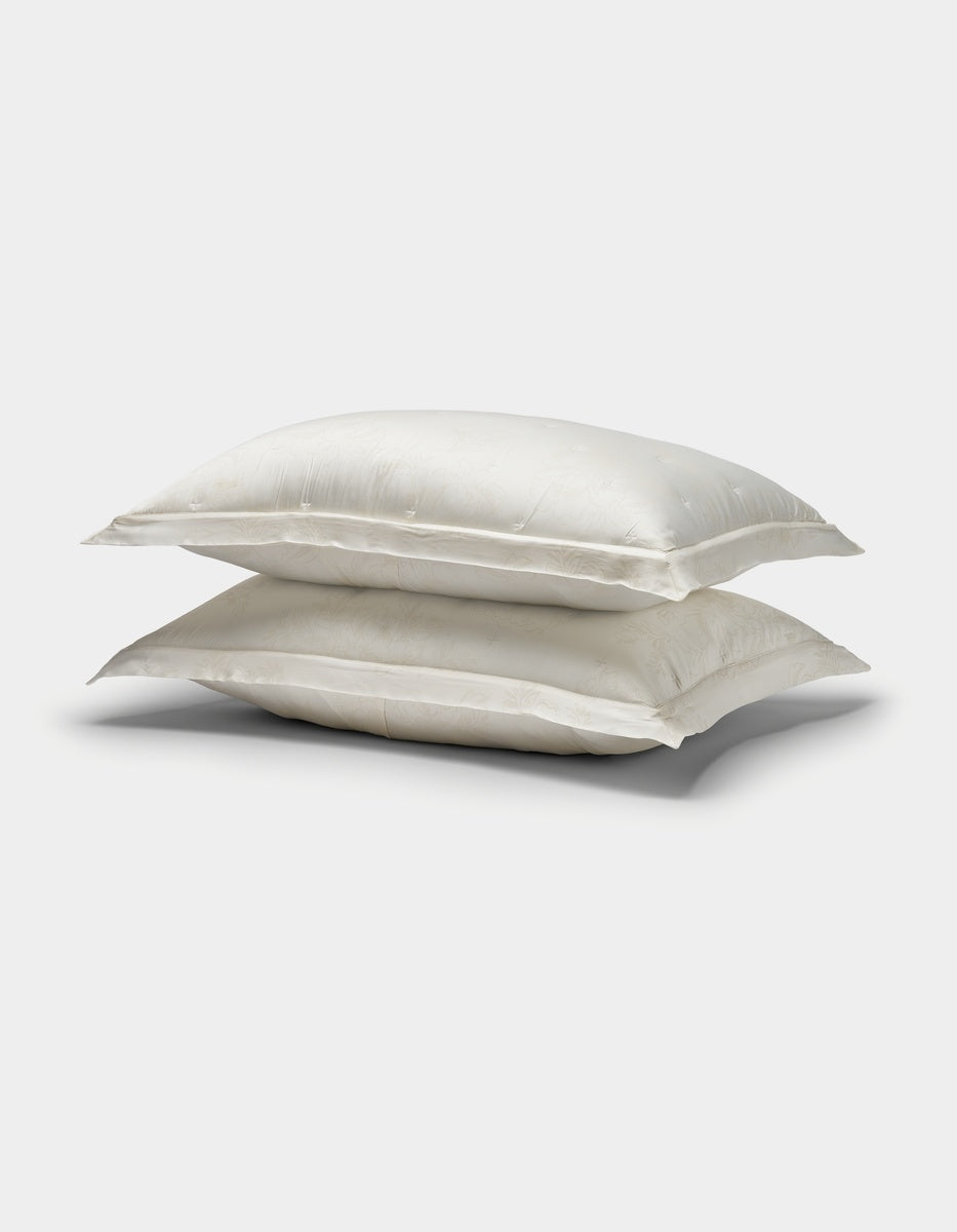 Two Cozy Earth Bamboo Quilted Shams in white, stacked on top of each other against a plain white background.|Color:Sonoma Floral in Vintage White