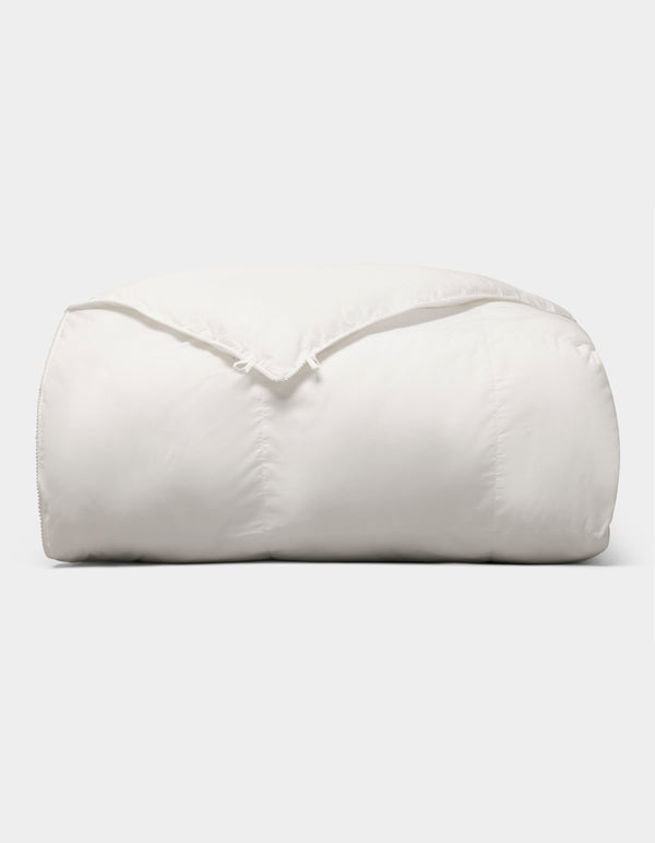 The Cozy Earth Down Alternative Comforter is neatly folded and fluffy, displayed against a plain light gray background. |Filling:Standard