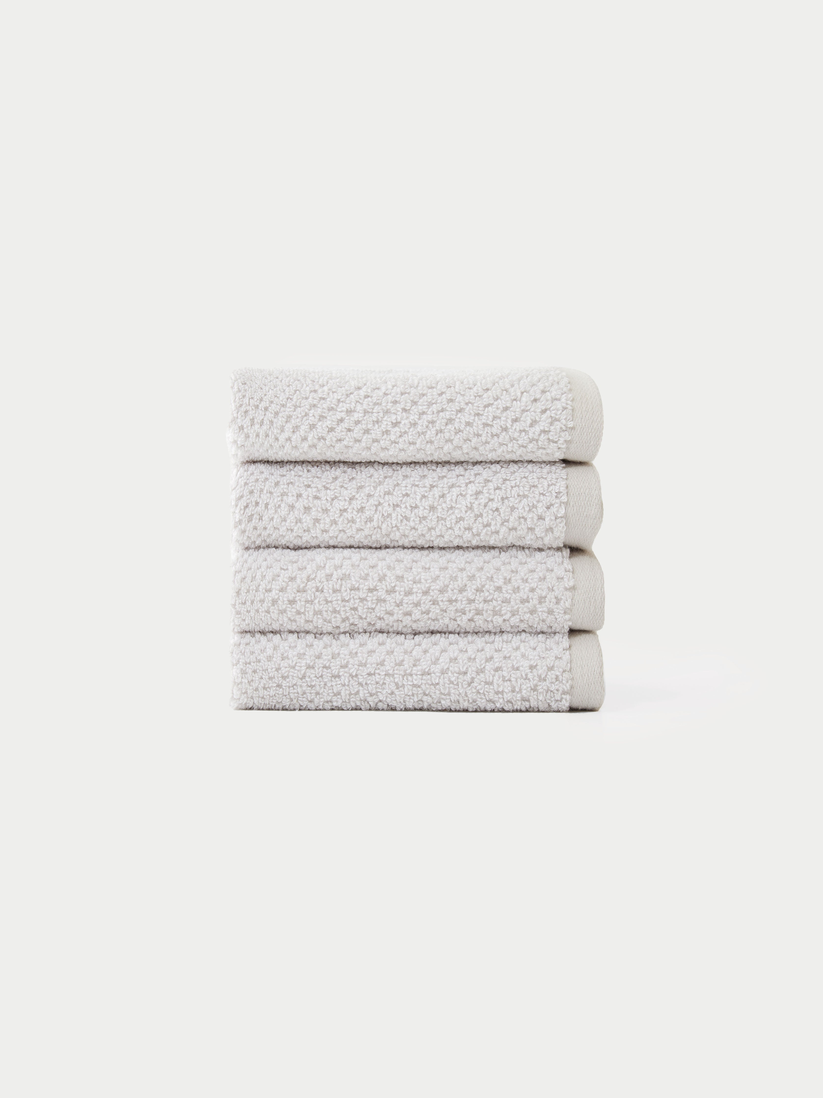 Nantucket Wash Cloths in the color Heathered Light Grey. The Wash Cloths are neatly folded. The photo of the wash cloths was taken with a white background.|Color:Heathered Light Grey