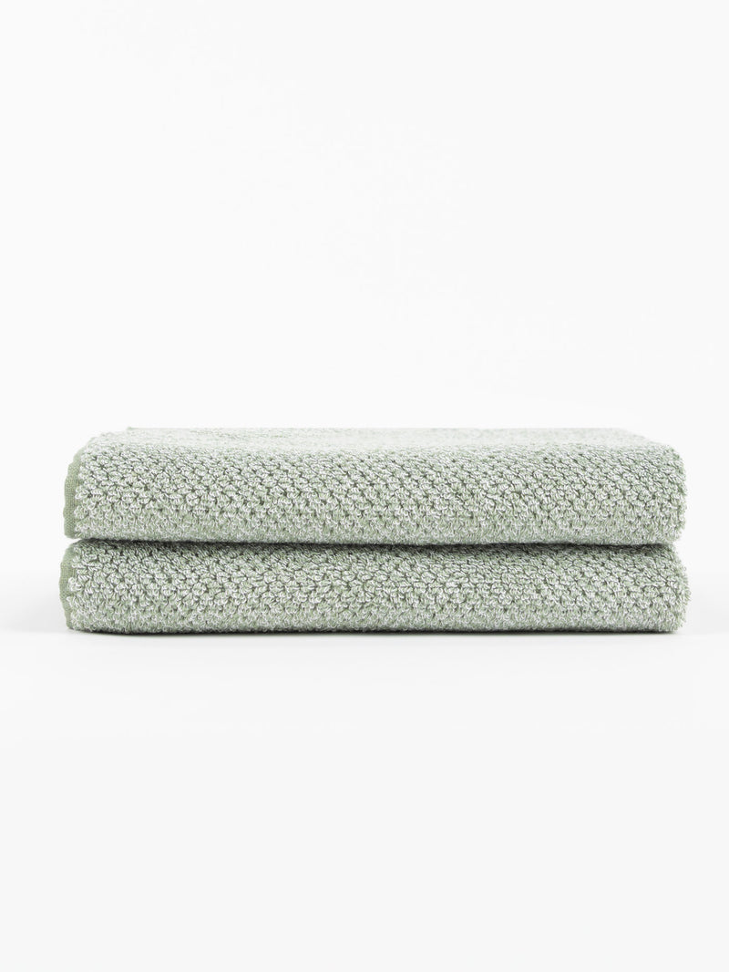 A pair of Nantucket Bath Towels in Heathered Clay are stacked.