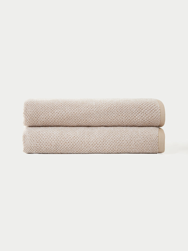 Nantucket Bath Sheets in the color Heathered Sand. The bath sheets are neatly folded. The photo of the bath sheets was taken with a white background.