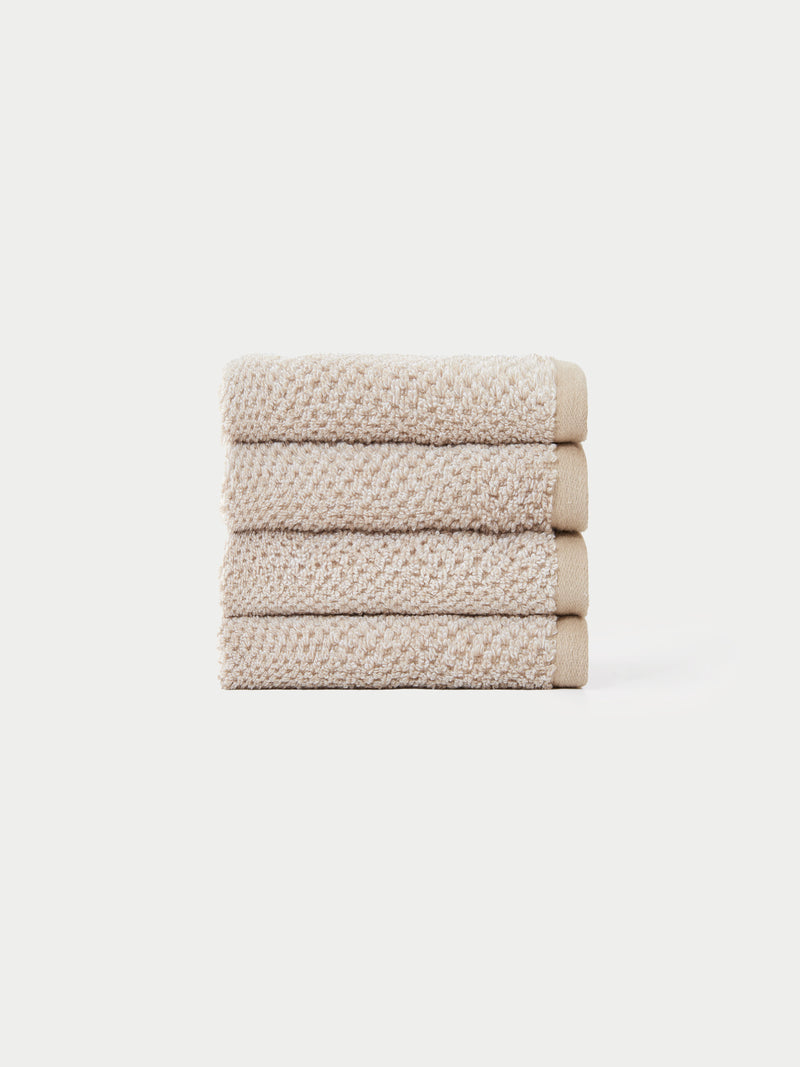 Nantucket Wash Cloths in the color Heathered Sand. The Wash Cloths are neatly folded. The photo of the wash cloths was taken with a white background.