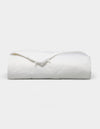 The Bamboo Viscose All Season Comforter by Cozy Earth, featuring a neatly folded white design with a subtle sheen, is displayed against a plain light background.|Filling:Standard 