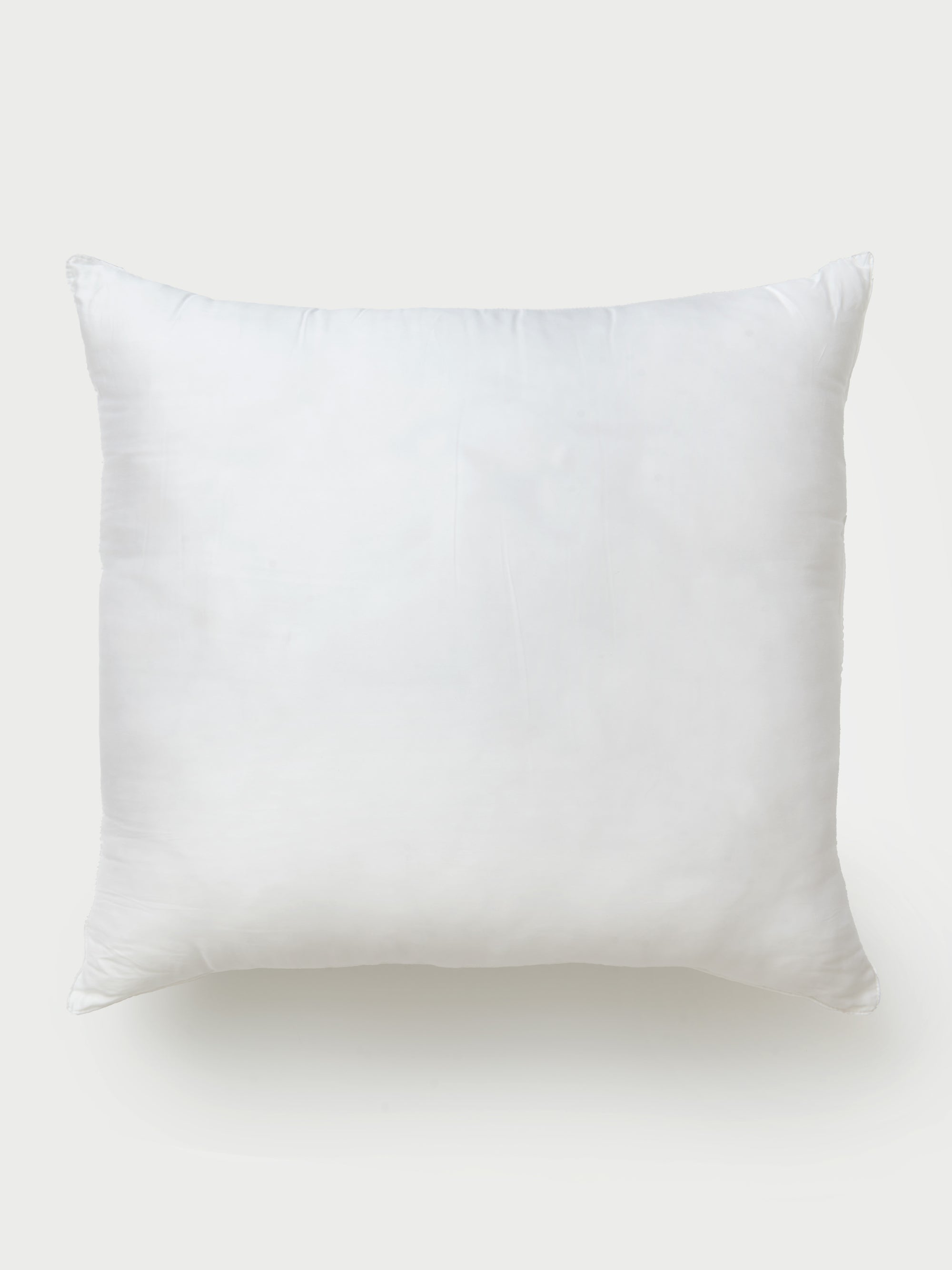 A Cozy Earth Premium Down Alternative Insert, featuring a smooth, plain surface and plump, soft appearance, is centered against a light gray background. The pillow exudes comfort, suggesting it offers excellent support for sleeping or lounging. 