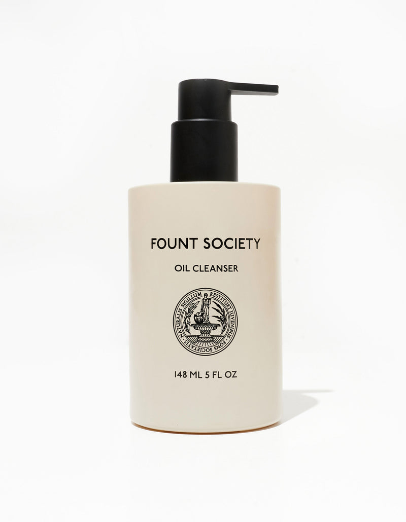 A beige cylindrical pump bottle labeled "COZY EARTH REVITALIZING PAIR" with a detailed round emblem in the center. The bottle contains 148 ml (5 fl oz) of product, and the pump is black. The background is plain white.