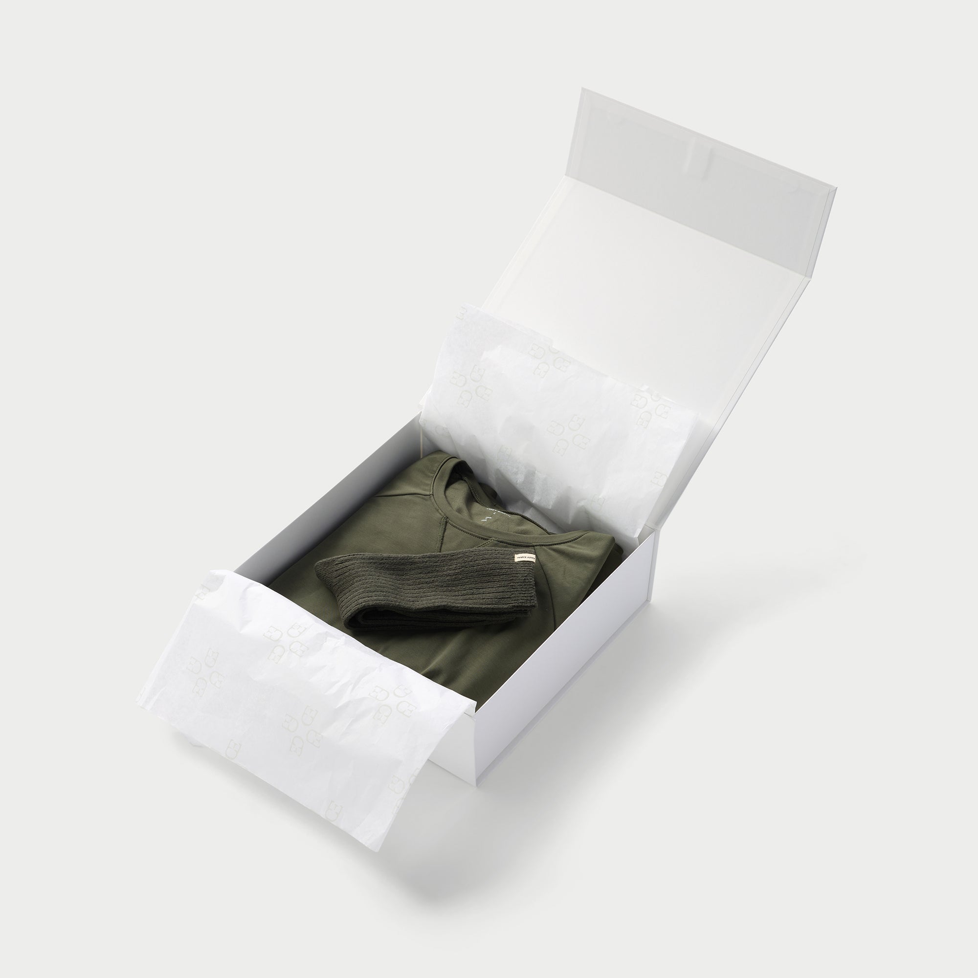 Small open gift box with cozy earth products inside 