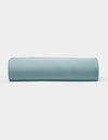 A neatly rolled light blue Bamboo Fitted Sheet by Cozy Earth is displayed against a plain white background.|Color:River