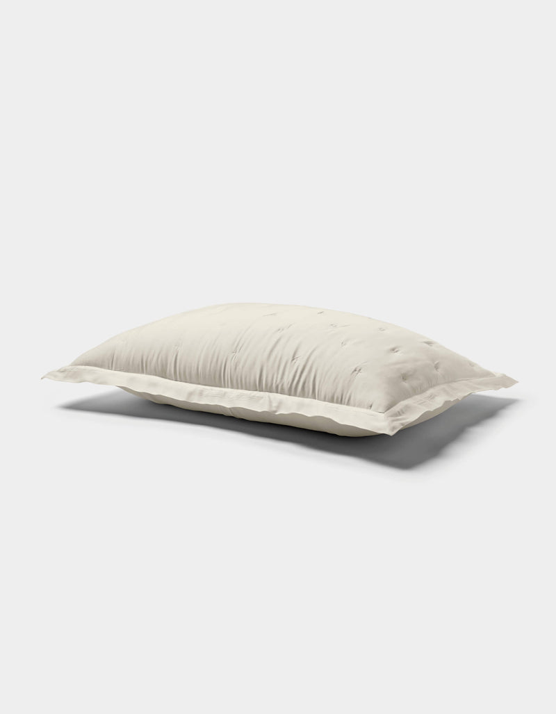 The Cozy Earth Bamboo Quilted Shams are shown against a plain white background, featuring a soft, white surface with subtle tufted details and gentle quilting.