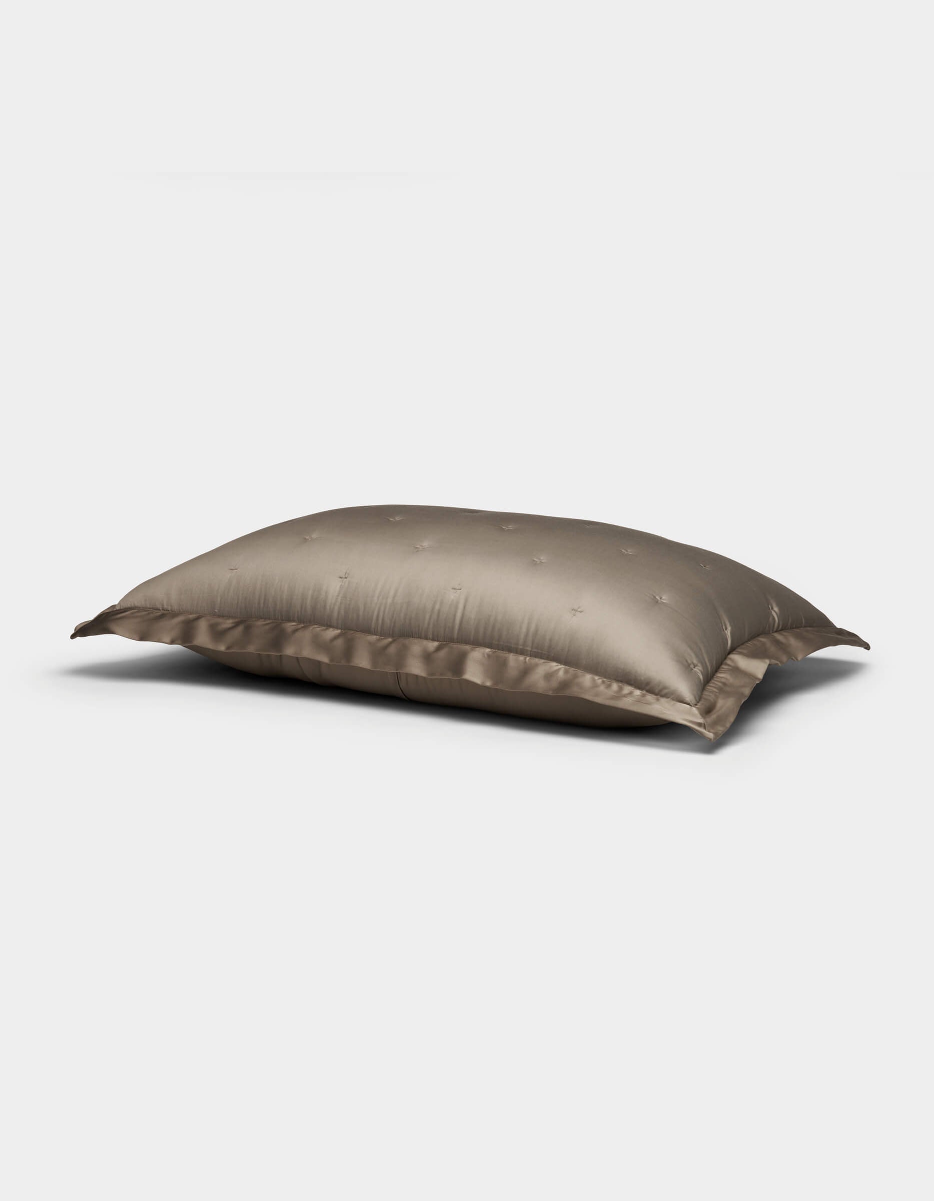 The Bamboo Quilted Shams by Cozy Earth feature a plush, rectangular design with a smooth, shiny taupe cover and subtle embroidered dots, shown against a plain white background.