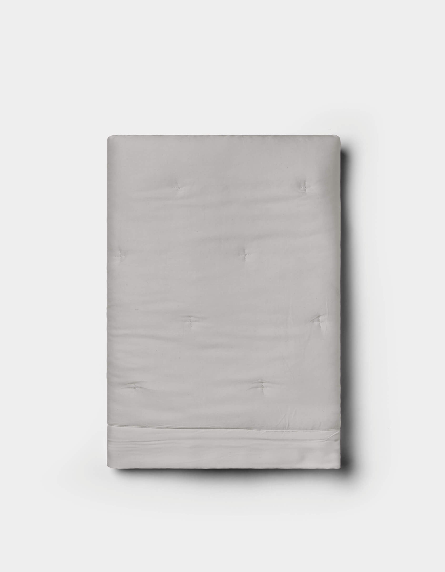 A neatly folded Cozy Earth Bamboo Quilted Sham in light gray with subtle tufted details, displayed against a plain white background.