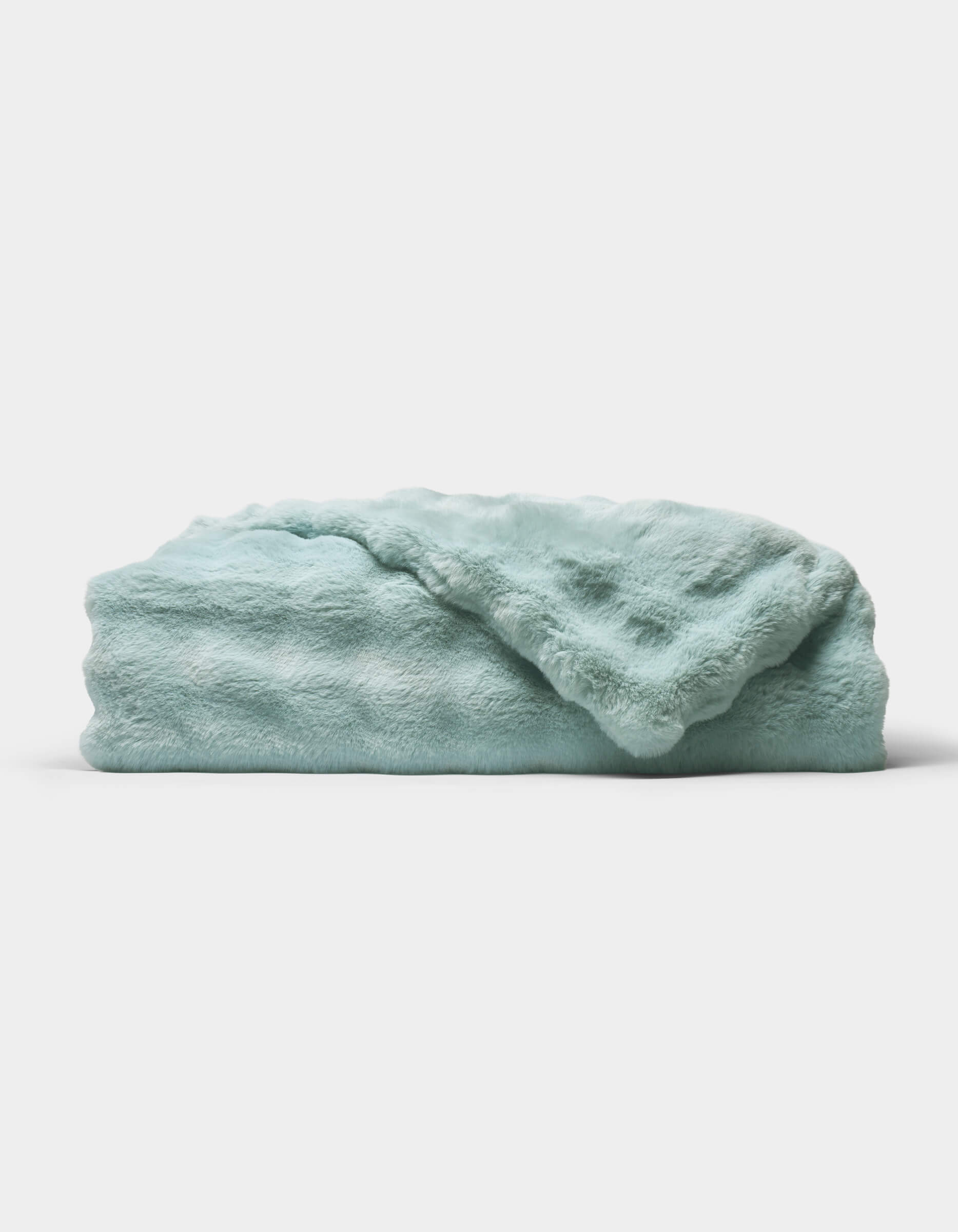The Bubble Cuddle Blanket by Cozy Earth, in a soft light blue, is shown folded neatly on a white background.