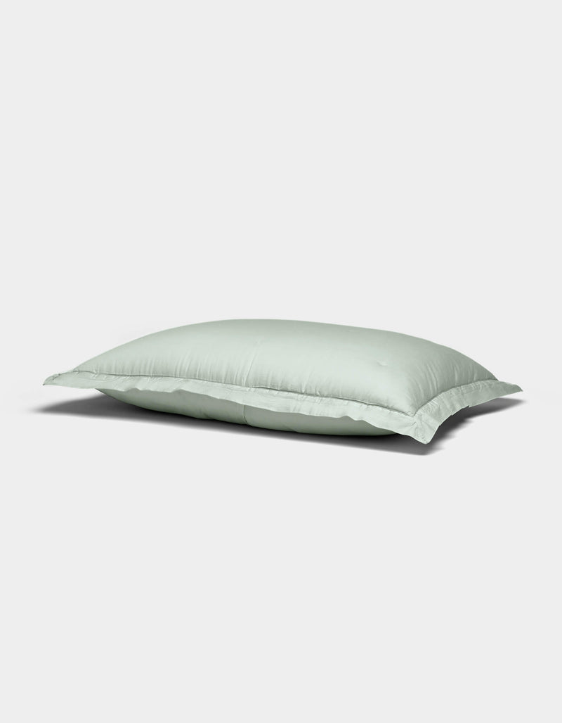 The Soft-Wash Cotton Quilted Shams by Cozy Earth feature a light blue rectangular design with a smooth surface, displayed against a plain white background.
