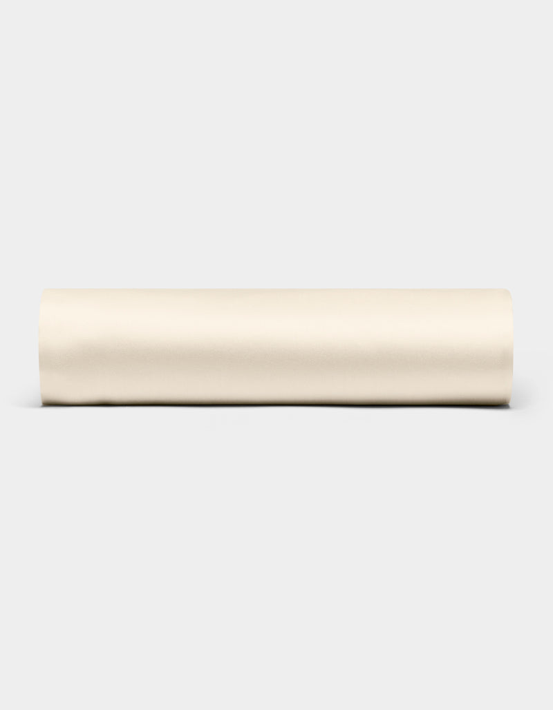 A Bamboo Fitted Sheet by Cozy Earth is displayed horizontally against a plain light gray background.
