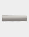 A Bamboo Fitted Sheet by Cozy Earth in light gray is displayed from the side against a plain white background.|Color:Light Grey