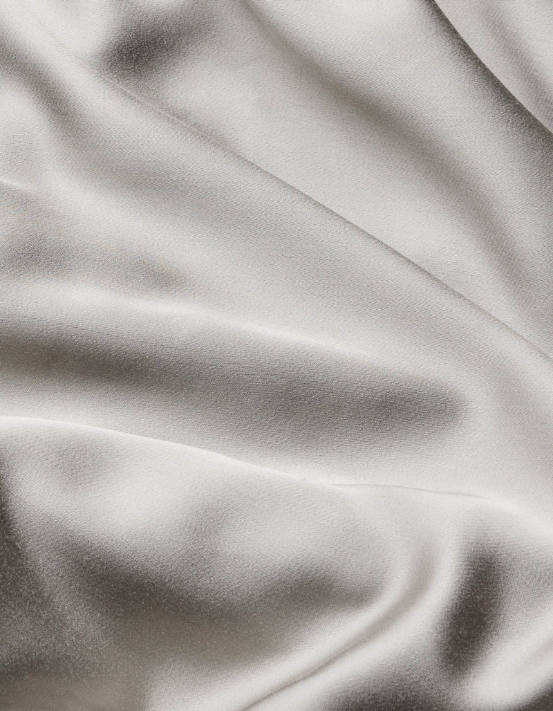 Close-up of Cozy Earth Bamboo Sheet Set featuring smooth, light-colored fabric with gentle folds and a subtle sheen for a soft, elegant texture.