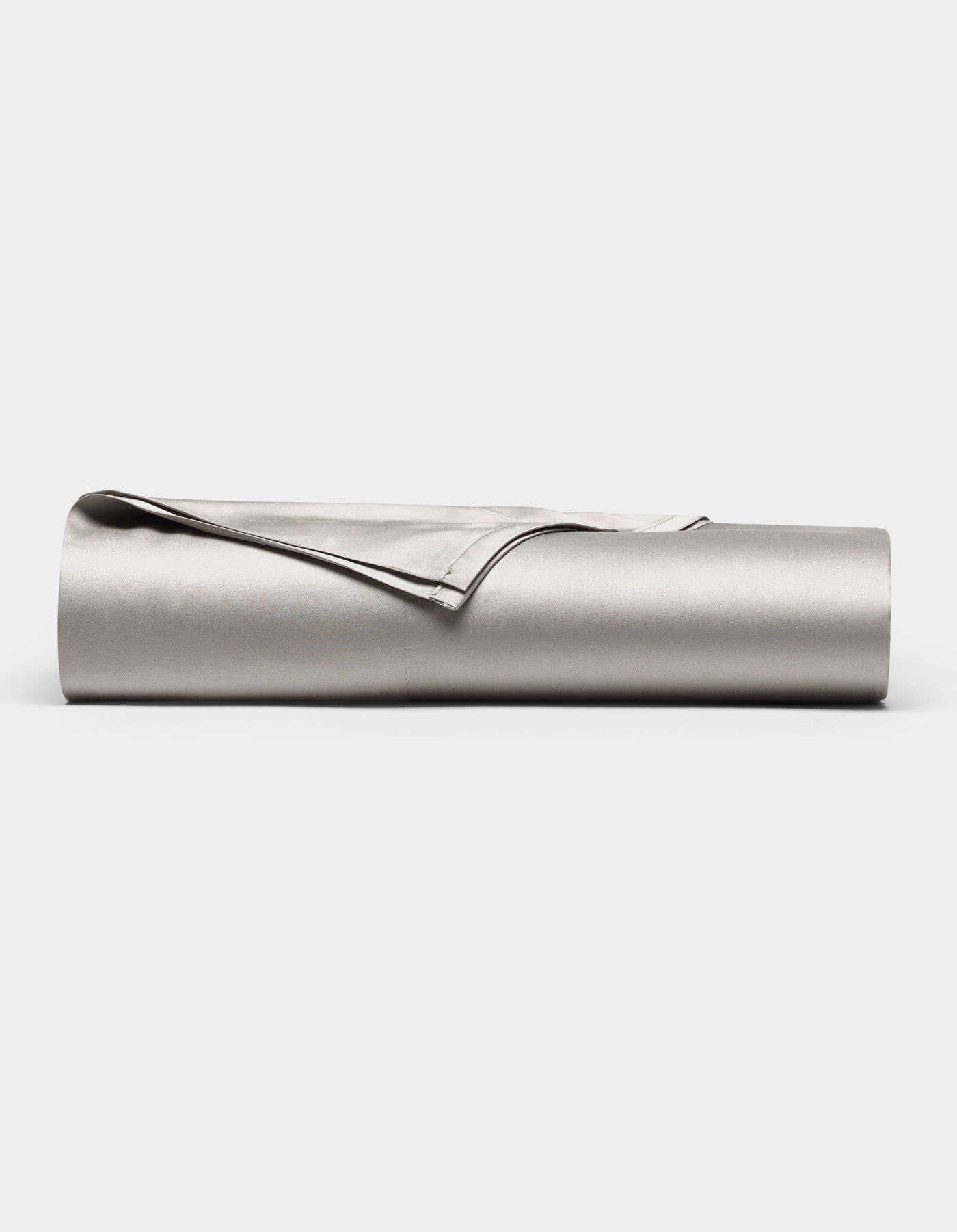 The Cozy Earth Bamboo Flat Sheet, shown in light gray with one corner folded over, is neatly rolled up and displayed against a plain white background.|Color:Light Grey