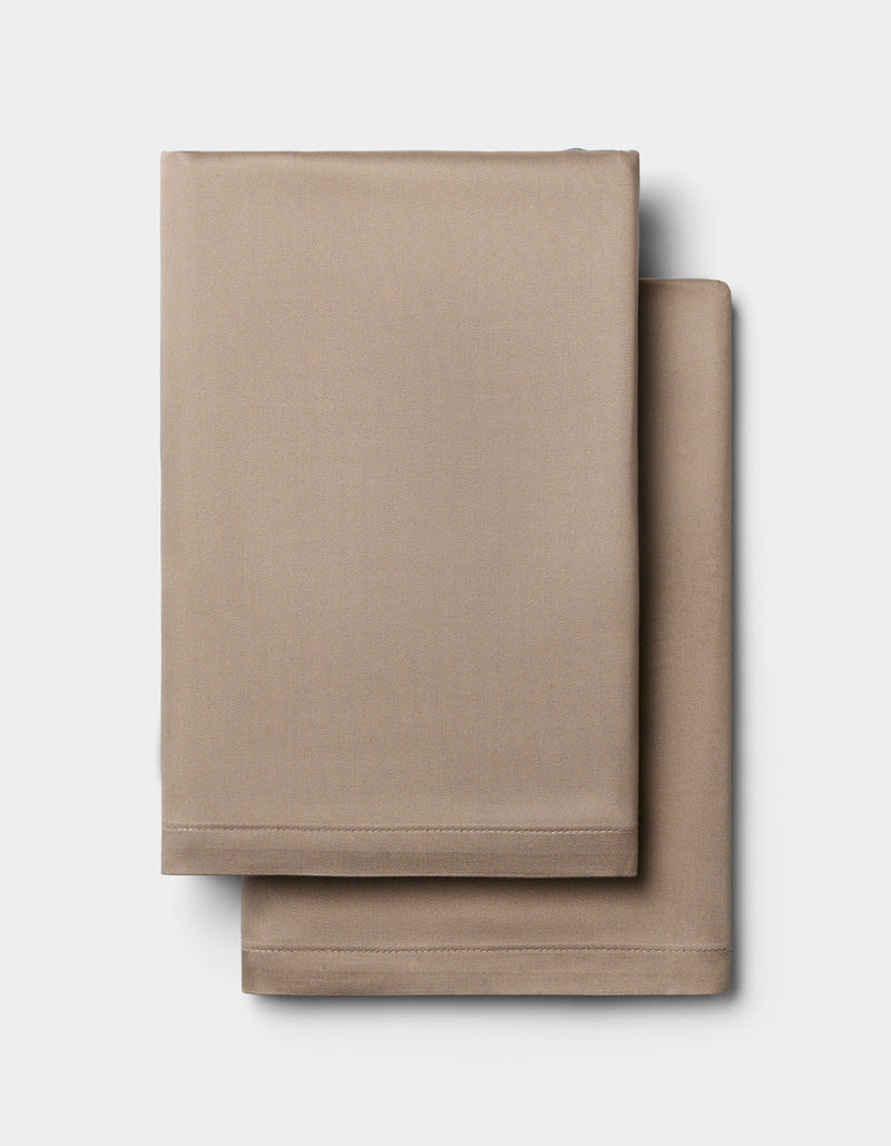 Two neatly folded Cozy Earth Bamboo Pillowcases are stacked on a plain white background.