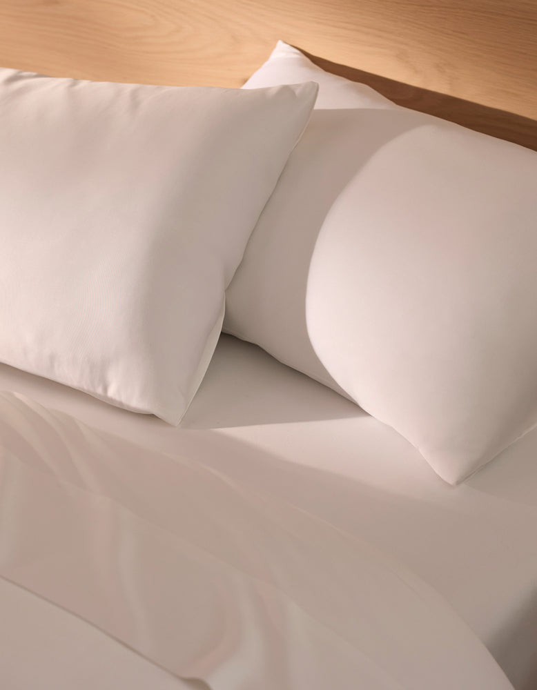 Close-up of white pillows on a bed with white Cozy Earth Bamboo bedding.|Color:white