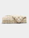 The Cozy Earth Bubble Cuddle Blanket is a folded, cream-colored faux fur throw with a soft, plush texture, shown against a plain white background.|Color:Creme