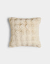 The Bubble Cuddle Pillow by Cozy Earth is a square, cream-colored pillow with a soft, fur-like texture, displayed against a plain white background.|Color:Creme |Size:20" x 20"