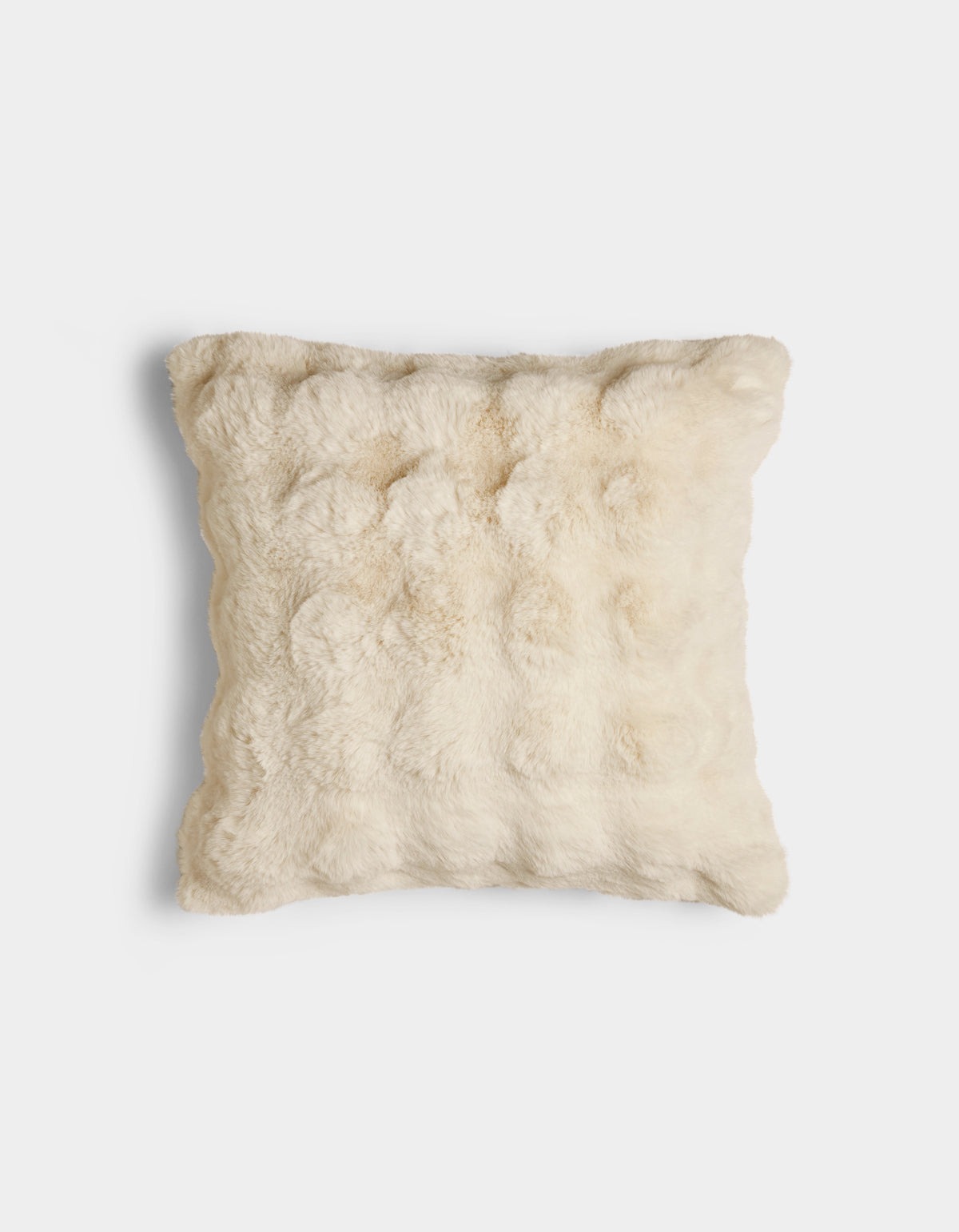 The Bubble Cuddle Pillow by Cozy Earth is a square, cream-colored pillow with a soft, fur-like texture, displayed against a plain white background.|Color:Creme |Size:20" x 20"