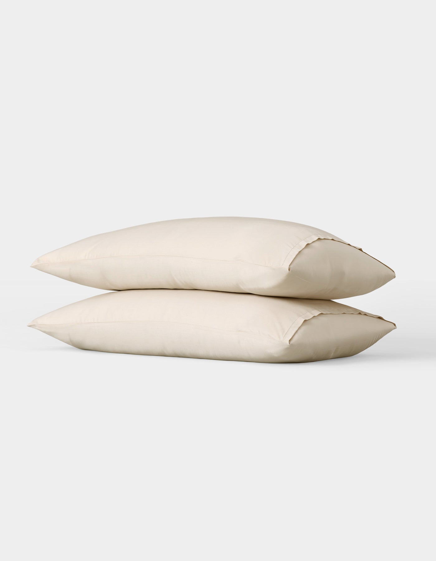 Two Cozy Earth Bamboo Pillowcases in cream are stacked together against a plain white background.|Color:Creme