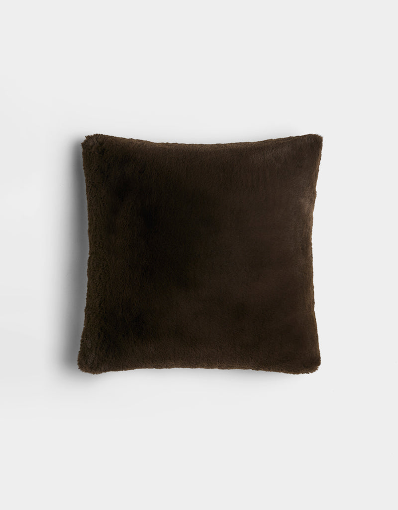 The Cozy Earth Cuddle Pillow is a square, dark brown plush pillow with a soft, fuzzy texture, displayed against a plain white background.