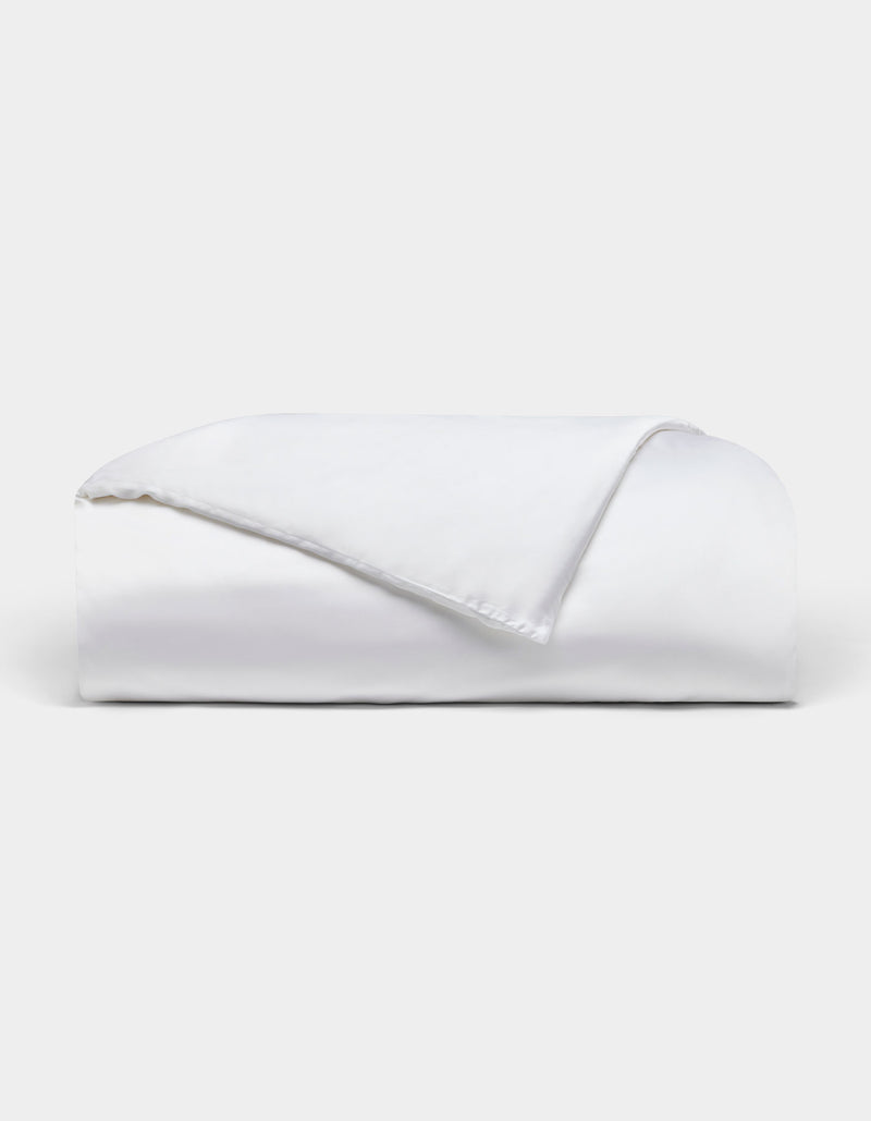 The Bamboo Duvet Cover by Cozy Earth is neatly folded with one corner flipped over, showcased against a plain light background.