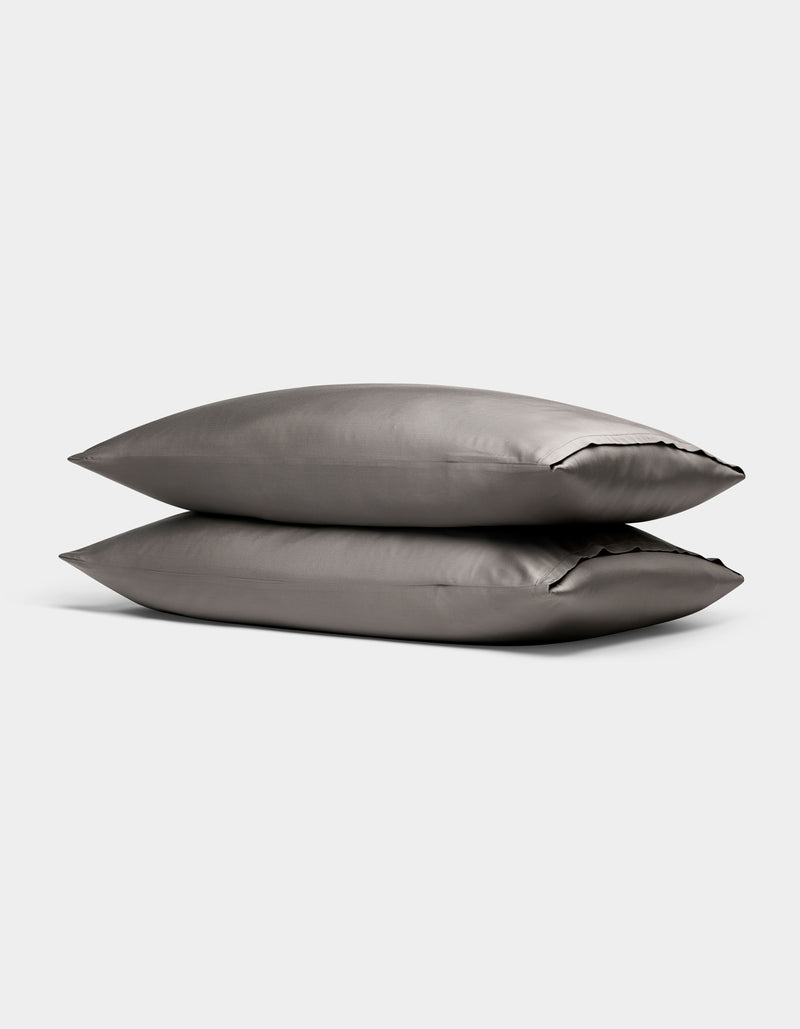 Two Cozy Earth Bamboo Pillowcases in gray are stacked together against a plain light background.