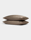 Two Cozy Earth Bamboo Pillowcases in taupe, rectangular and neatly stacked on top of each other, are displayed against a plain light gray background.|Color:Walnut