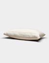 The Baja Matelasse Sham by Cozy Earth, in a cream shade with subtle horizontal stripes, rests on a plain light gray background. Its soft, gently flattened appearance suggests both comfort and support.|Color:Alabaster/Oceanside