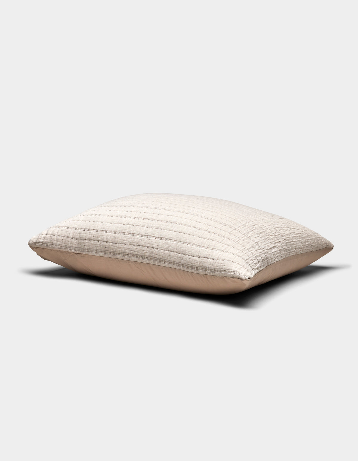 The Cozy Earth Baja Matelasse Sham is a beige, rectangular pillow sham with a textured quilted pattern, shown against a plain white background. The fabric appears soft and slightly puffed.|Color:Ebony/Taupe