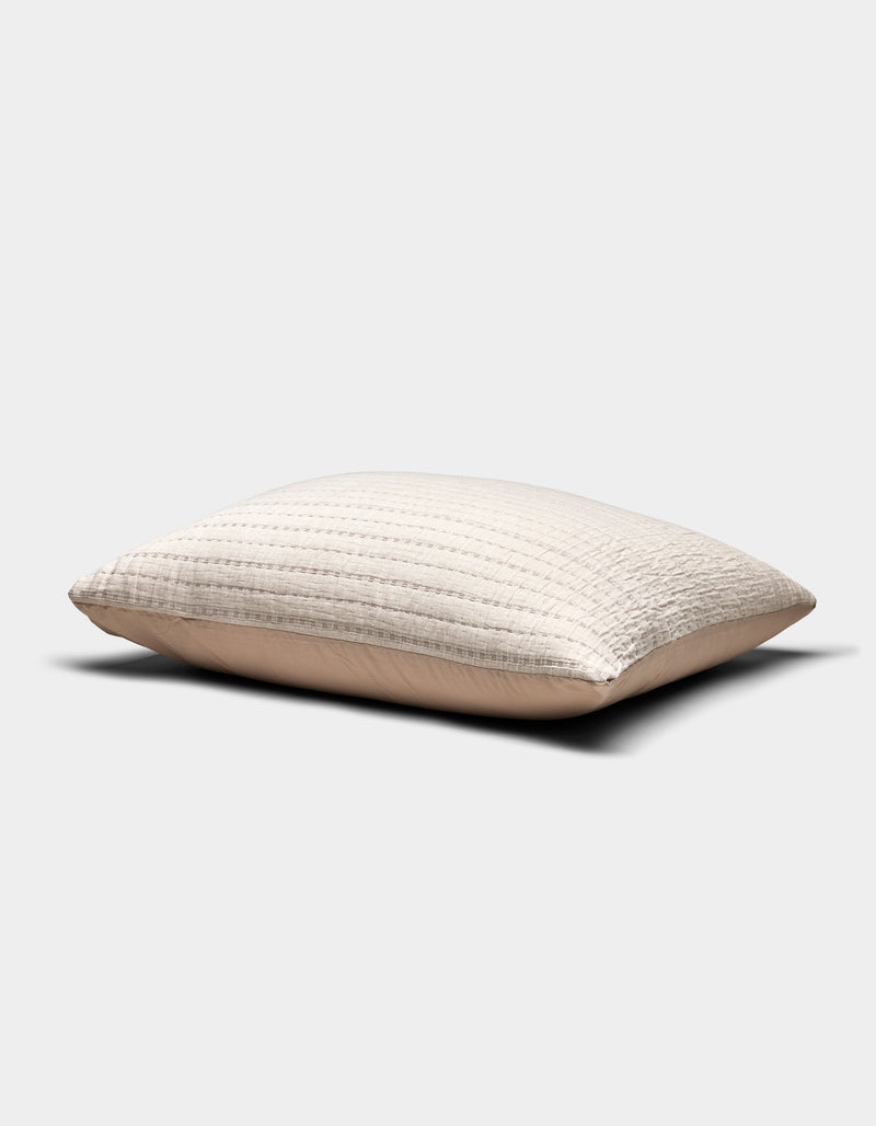 The Cozy Earth Baja Matelasse Sham is a beige, rectangular pillow sham with a textured quilted pattern, shown against a plain white background. The fabric appears soft and slightly puffed.