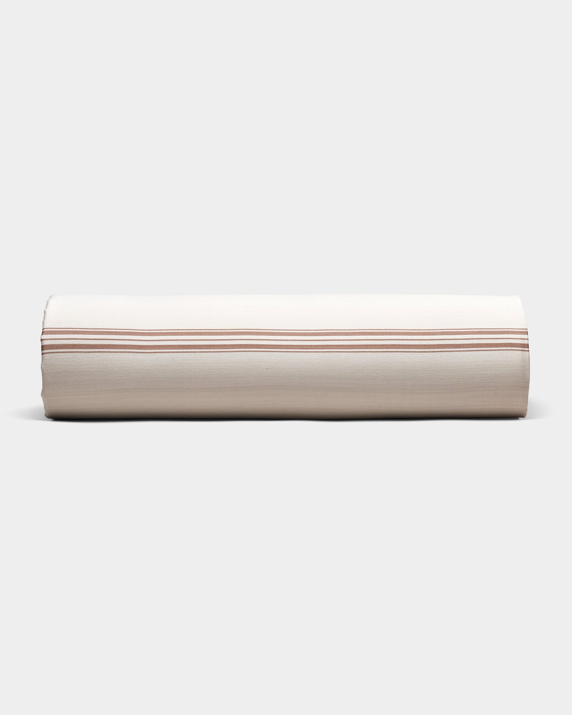 The Cozy Earth Bamboo Sheet Set is shown neatly rolled in beige fabric with thin, evenly spaced brown stripes, on a plain light gray background.|Color:Baja Stripe in Maple