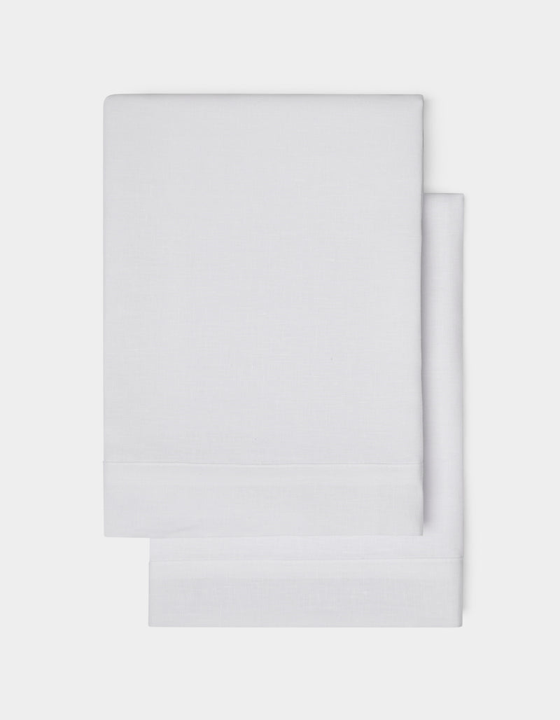 Cozy Earth Linen Shams, neatly folded in plain white with a simple hemmed edge, are shown on a white background.