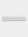 A Soft-Wash Cotton Fitted Sheet by Cozy Earth, in plain white, is displayed horizontally against a light gray background, viewed from the side.|Color:White