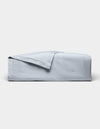 The Cozy Earth Soft-Wash Cotton Quilt, in light blue with a matching folded-back corner, is displayed on a plain white background.|Color:Shore