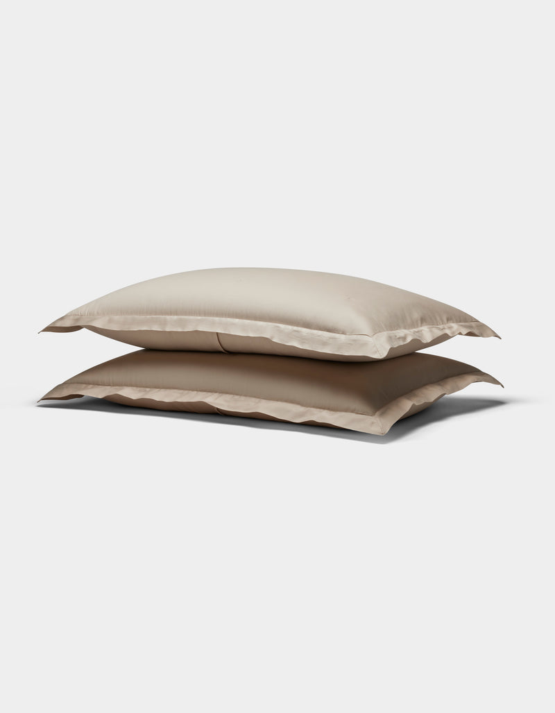 Two Soft-Wash Cotton Quilted Shams by Cozy Earth, in beige, stacked atop each other against a plain white background.