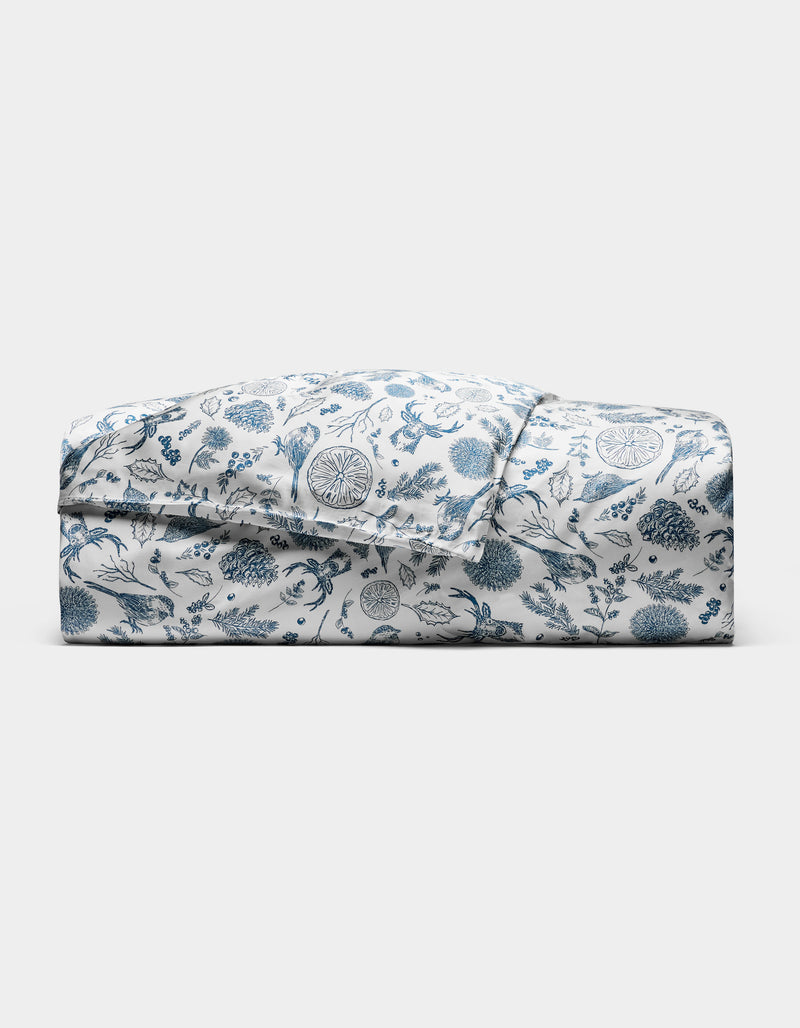 The Cozy Earth Bamboo Duvet Cover features a blue floral and botanical print on white, neatly folded and displayed against a plain white background.