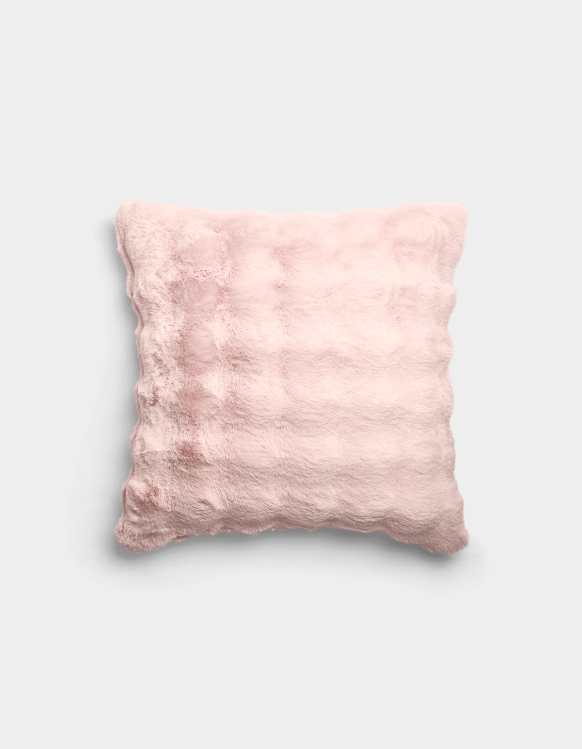 The Bubble Cuddle Pillow by Cozy Earth is a square, pale pink plush pillow with a soft, fuzzy texture and subtle horizontal ridges, shown against a plain light gray background.|Color:Blossom |Size:20" x 20"
