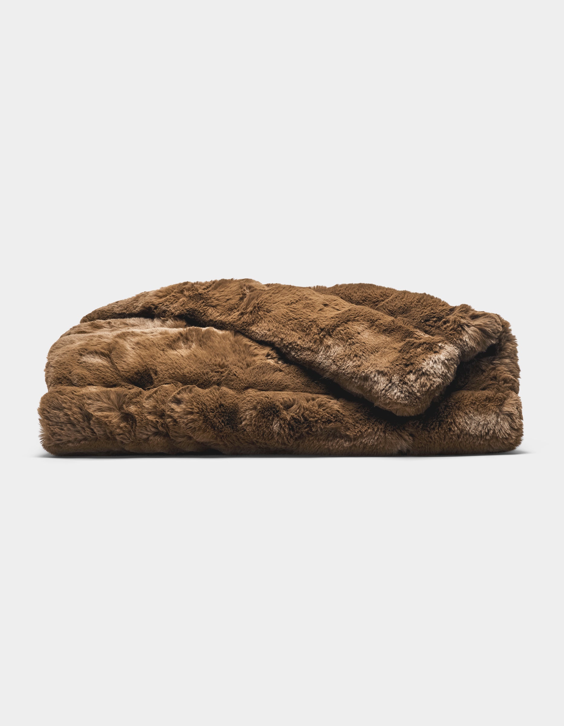 The Cozy Earth Channel Cuddle Blanket, a folded plush brown faux fur throw, is displayed against a plain white background.