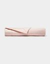 The Cozy Earth Little Bee Matelasse Baby Blanket is neatly folded, showcasing its light pink, textured surface against a plain white background.|Color:Petal