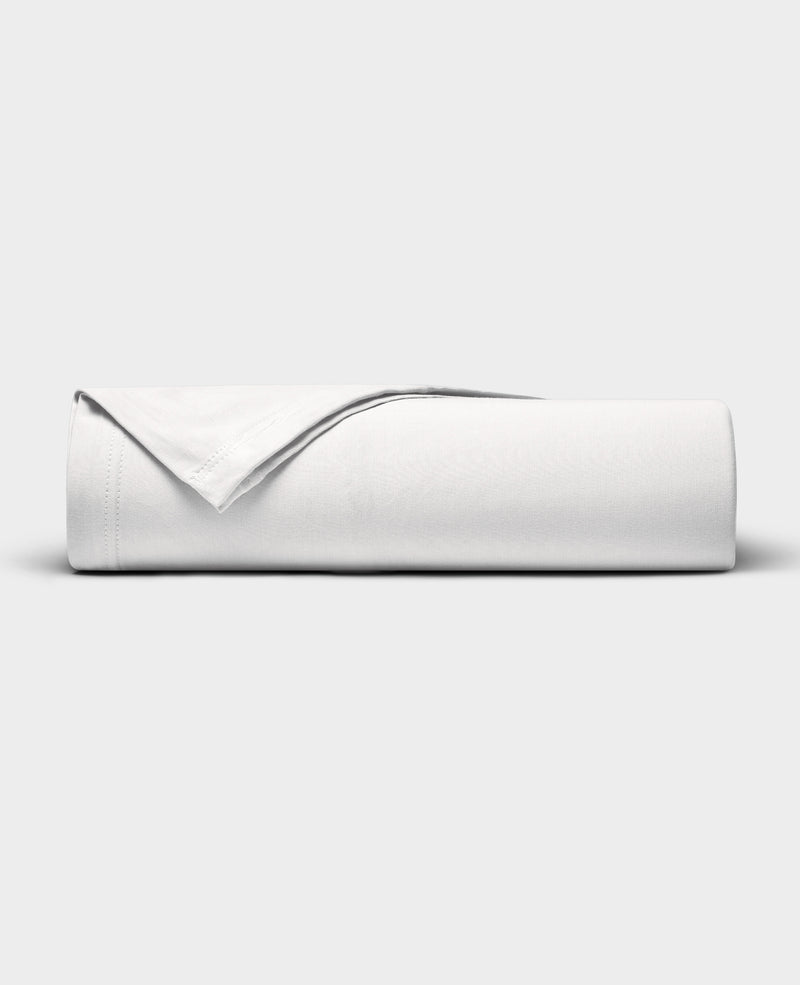 The Cozy Earth Bamboo Jersey Flat Sheet is neatly folded with a corner turned back, showcased against a plain light gray background.