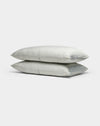 Two light gray, striped Cozy Earth Bamboo Pillowcases are stacked neatly atop each other against a plain white background.|Color:Classic Stripe in Laurel
