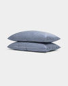 Two Cozy Earth Bamboo Pillowcases, blue-and-white striped, are stacked neatly against a plain white background.|Color:Classic Stripe in Pacific