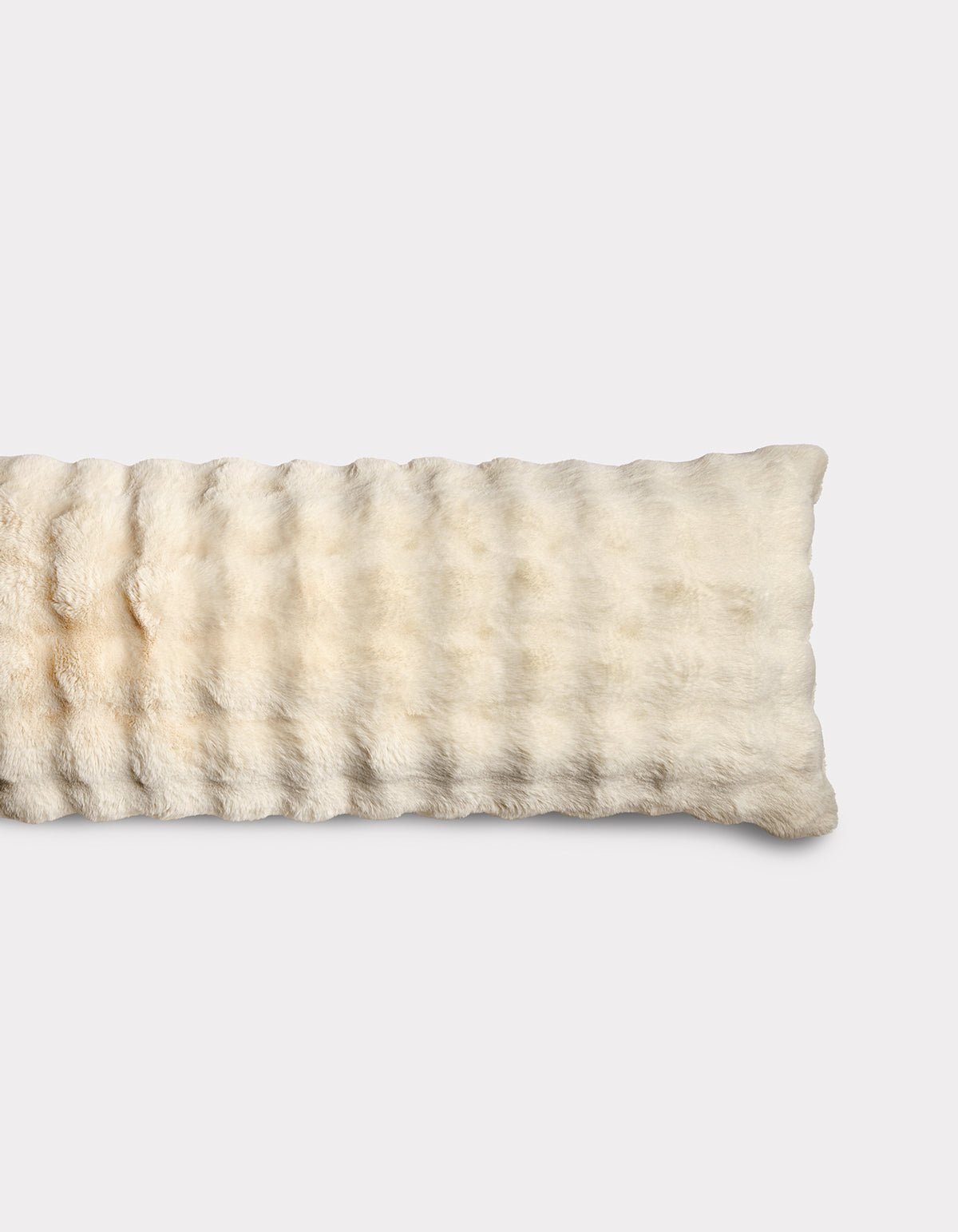 The Bubble Cuddle Pillow by Cozy Earth is a rectangular, cream-colored plush pad with a soft, furry texture, shown lying flat on a plain white background.|Color:Creme |Size:Body